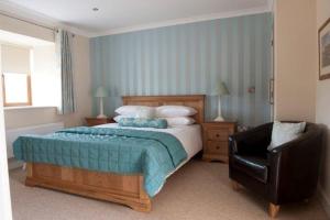 A bed or beds in a room at The Harp at Letterston