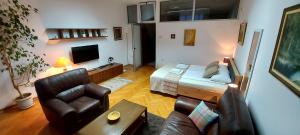a living room with a bed and a couch at GM Apart-Hotel in Niš