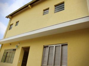 a yellow building with windows on the side of it at Residence Barueri in Barueri