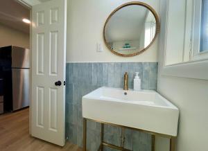 a bathroom with a white sink and a mirror at Cathedral Studio in Omaha