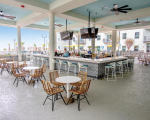 a restaurant with tables and chairs and a bar at Holiday Inn Club Vacations Myrtle Beach Oceanfront, an IHG Hotel in Myrtle Beach