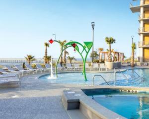 a swimming pool with chairs and a hotel at Holiday Inn Club Vacations Myrtle Beach Oceanfront in Myrtle Beach