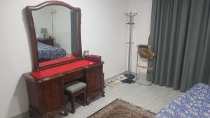 a dressing room with a mirror and a piano at M apartment in Kuwait