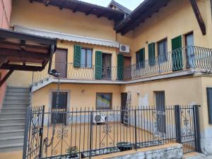 an apartment building with balconies and a fence at SWEET HOME in Azzano San Paolo