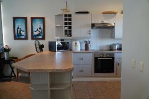 a kitchen with a counter top with a microwave at Pinnacle Point Golf Estate Lodge 78 in Mossel Bay