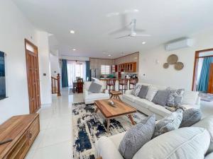 a living room with a couch and a table at Seaside Bliss Vipingo in Tezo