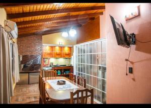 a kitchen with a dining room table and a television at Blue Apart 2 in Puerto Rico