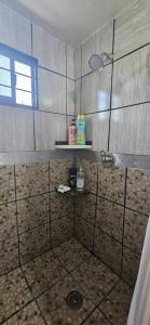a bathroom with a shower with a sink and a shelf at Departamento un salto a la frontera in Piedras Negras