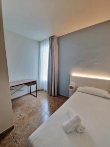 מיטה או מיטות בחדר ב-Hostal Rugaca