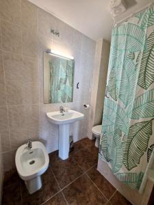 a bathroom with a sink and a toilet at Hostal Rugaca in Huesca