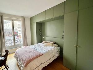 a green bedroom with a bed and a window at 205sm luxury and design flat at Paris Montmartre in Paris