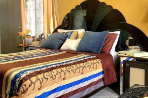 Un dormitorio con una cama con almohadas de colores. en Departamento un salto a la frontera en Piedras Negras