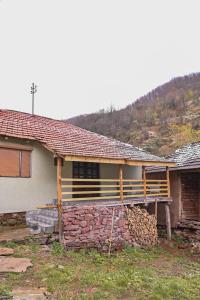 una casa con una pared de piedra de retención delante de ella en Kuća Cvetković en Pirot