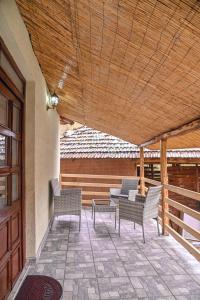 a porch with chairs and a wooden ceiling at Kuća Cvetković in Pirot