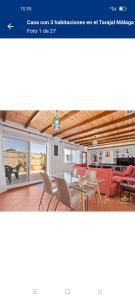 a website of a living room with tables and chairs at Casa El Tarajal in Málaga