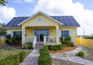 a house with solar panels on the roof at The Sunflower Villa in Grand Turk