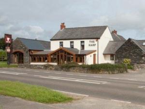 a large white building on the side of a road at The Harp at Letterston in Letterston