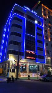 a hotel with blue lights on the front of it at Jiger Palace Hotel in Erbil