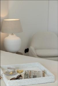 a tray with glasses and a lamp on a table at Wave Sea View in Międzyzdroje +68 photos