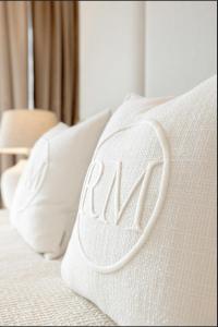 a row of white pillows on a bed at Wave Sea View in Międzyzdroje