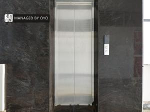 an elevator with a glass door in a building at OYO Sparrow Suites & Resorts Kattapana in Kattappana