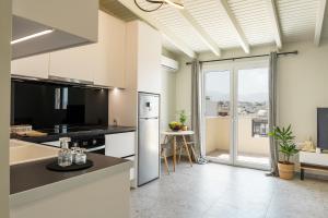 a kitchen with a refrigerator and a counter top at S12 Apartments in Heraklio