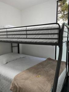 a bunk bed in a room next to a window at Casa 11 in Guatemala
