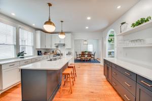 a kitchen with white cabinets and a large kitchen island at Elizabeth City Home with Fire Pit Less Than 1 Mi to Downtown in Elizabeth City