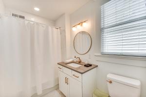 a white bathroom with a sink and a mirror at Elizabeth City Home with Fire Pit Less Than 1 Mi to Downtown in Elizabeth City +22 photos