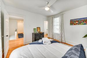 a white bedroom with a bed and a desk at Elizabeth City Home with Fire Pit Less Than 1 Mi to Downtown in Elizabeth City