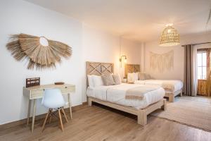 a bedroom with two beds and a desk and a desk at Casa Pandurata Luxury Apartments in Centro, San Miguel de Allende in San Miguel de Allende +86 photos