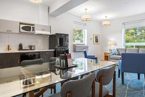 a kitchen and living room with a table and chairs at Crown Columbia Hotel; BW Premier Collection in Trail