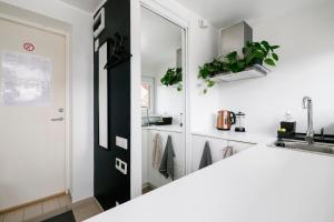 a kitchen with a sink and a mirror at Apartment for one - grey in Tallinn