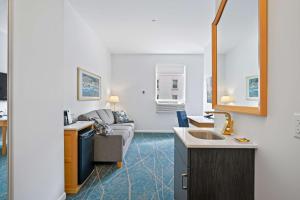 a kitchen and a living room with a couch at Crown Columbia Hotel; BW Premier Collection in Trail