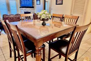 a dining room table with a vase of flowers on it at Abundantly Blessed Mountain View 3604 in Pigeon Forge