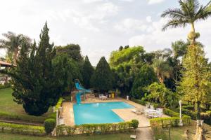 an image of a swimming pool in a garden at Chácara Nosso Sonho in Atibaia