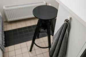 a stool sitting in a room next to a wall at Apartment for one - white in Tallinn