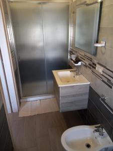 a bathroom with a sink and a shower at Belvedere Residence in Zungri +47 photos
