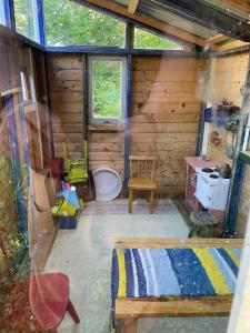 an inside view of a log cabin with a toilet at Mysig stuga i Rute med stor trädgård in Lärbro