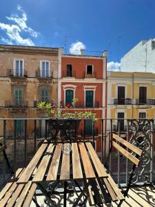 a wooden bench sitting on top of a balcony at Casa Garruba 99 in Bari +14 photos