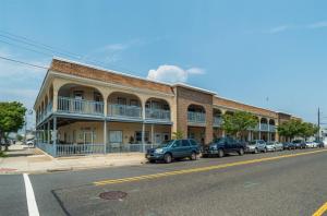a large brick building with cars parked in front of it at 5600 Seaview Ave, Unit 15 in Wildwood Crest