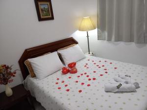 a bedroom with a bed with red hearts on it at 1 Quarto Turismo Teresópolis in Teresópolis