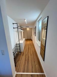 a room with a staircase and a room with white walls at Modernes Studio-Apartment in toller Waldrand-Lage in Kaiserslautern