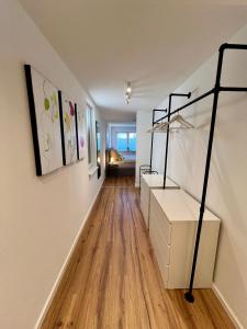 a hallway with a bed and a wooden floor at Modernes Studio-Apartment in toller Waldrand-Lage in Kaiserslautern