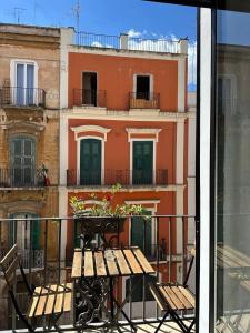 a balcony with a table and a view of a building at Casa Garruba 99 in Bari