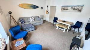a living room with a couch and chairs and a table at Heart of DARTMOUTH TOWN CENTER and with own PRIVATE PARKING - These Two Traditional Georgian SUPER STYLISH DUPLEX APARTMENTS are NEWLY REFURBISHED and have a CONNECTING DOOR For Larger Groups!!! in Dartmouth