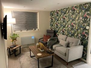 a living room with a couch and a table at The Cosy Cottage, Old Soles bridge Lane in Chorleywood