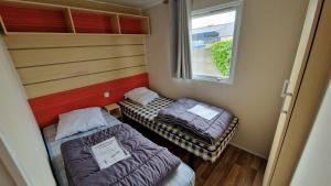 Postel nebo postele na pokoji v ubytování EGELE MOBILE-HOME prox Europapark et Rulantica