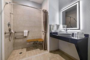 a bathroom with a sink and a shower at Studio 6 Suites Texas City, TX I 45 South in Texas City +25 photos