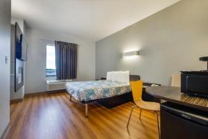 a small room with a bed and a table at Studio 6 Suites Texas City I-45 in Texas City
